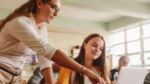Teacher helping student